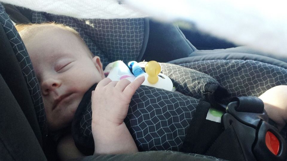 Belfast International Airport Children's Facilities - Baby sleeping in travel seat