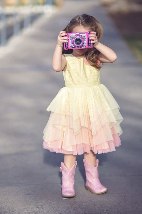 Belfast International Airport Children's Facilities - Belfast girl taking photo on holiday